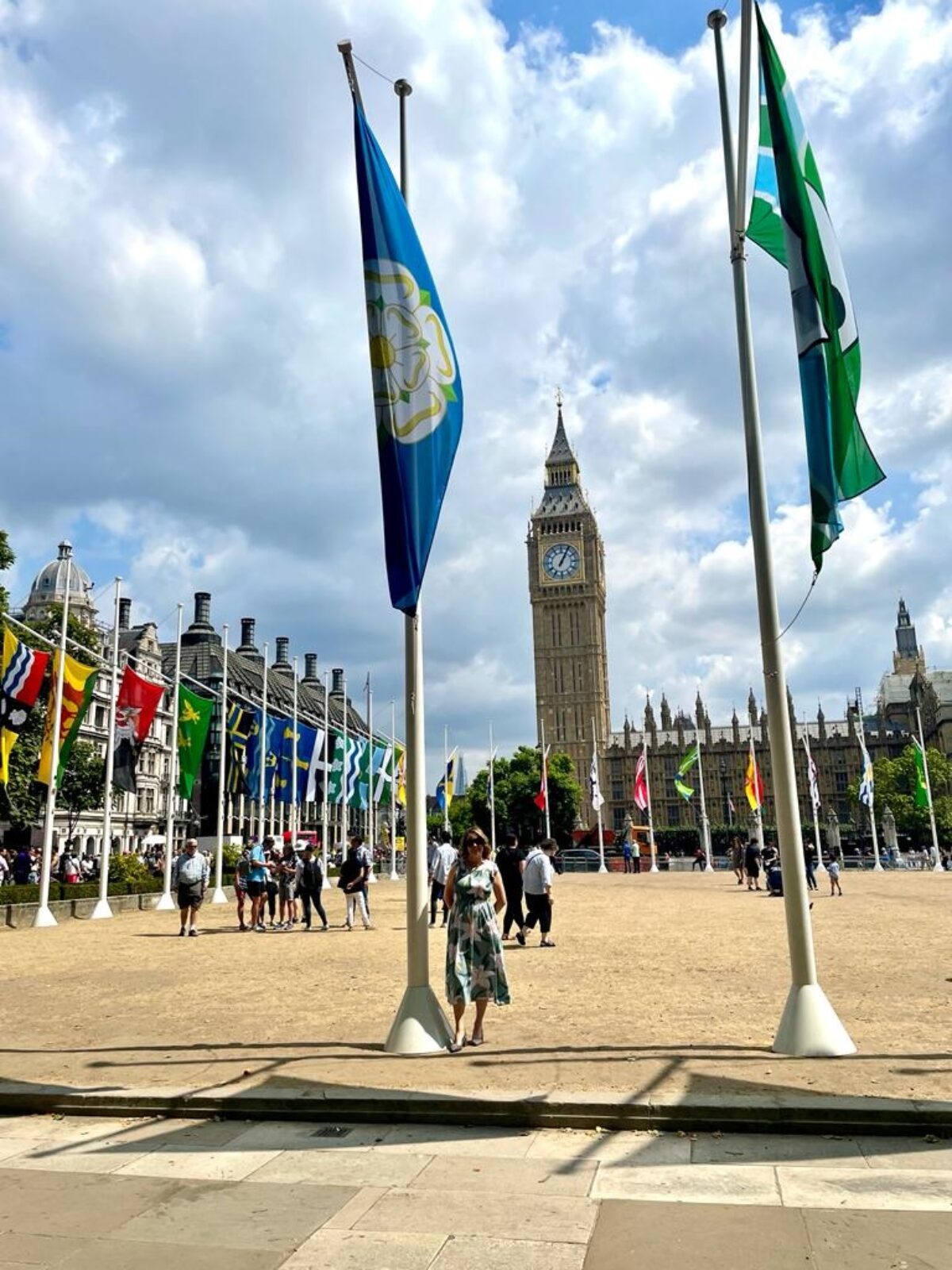 Stephanie Peacock MP standing outside the Houses of Parliament underneath the Yorkshire Flag