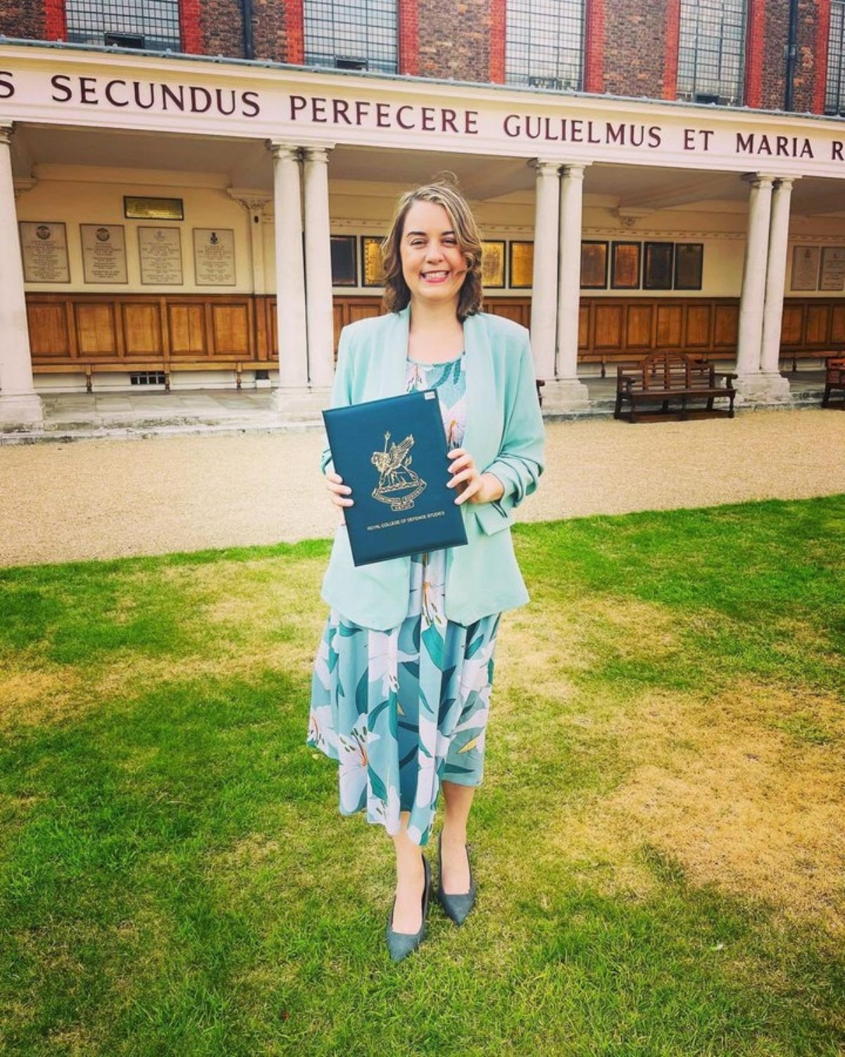 Stephanie Peacock holding her award at her graduation from the Royal College of Defence Studies