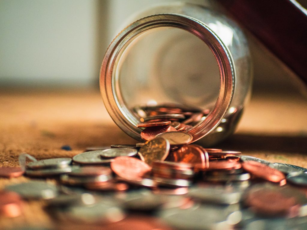 Jar with coins spilling out