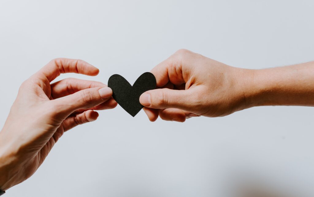 Image of heart passing between hands
