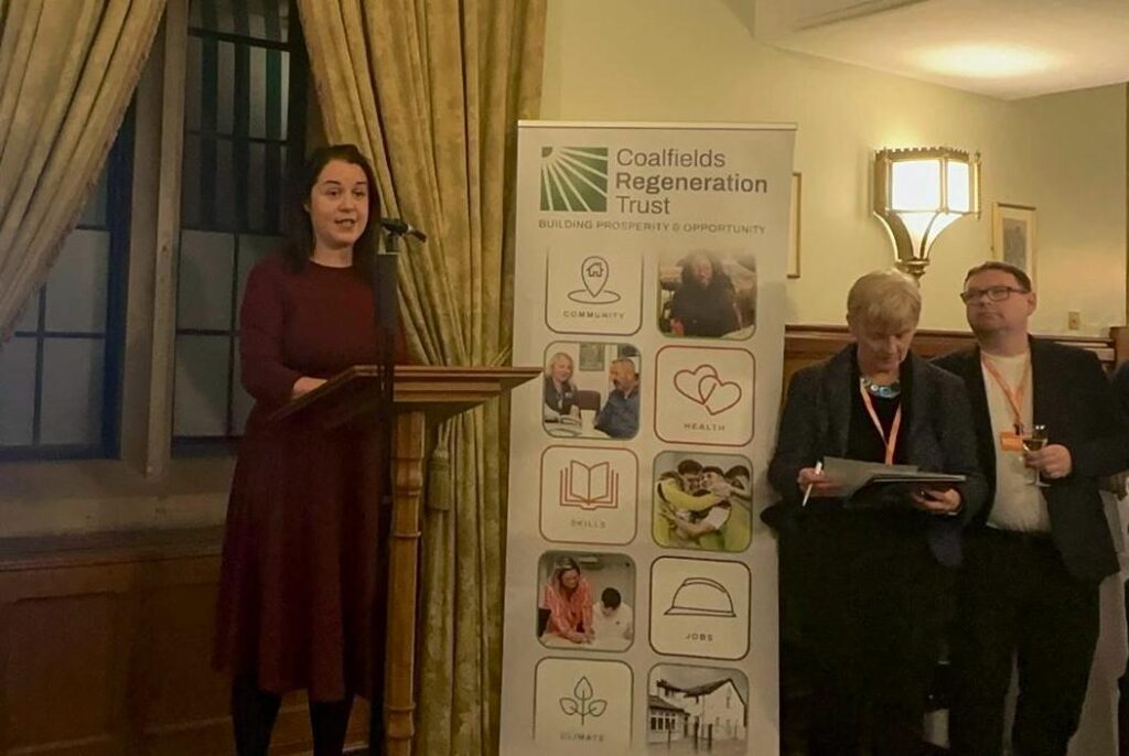 Stephanie Peacock MP speaking at a podium at the Coalfields Regeneration Trust's 25th Anniversary event in Parliament