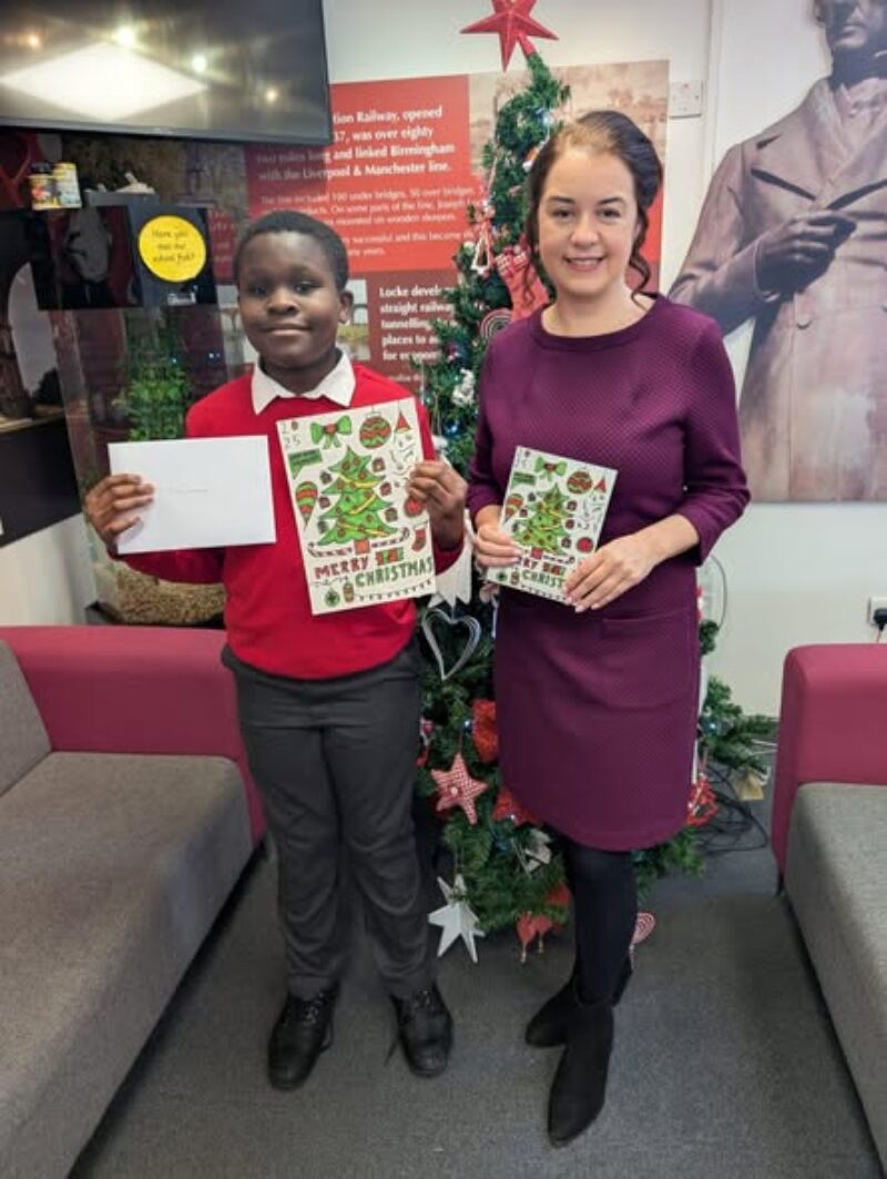 Stephanie Peacock MP presenting Muhammed from Joseph Locke Primary School with first prize for winning her annual Christmas Card Competition
